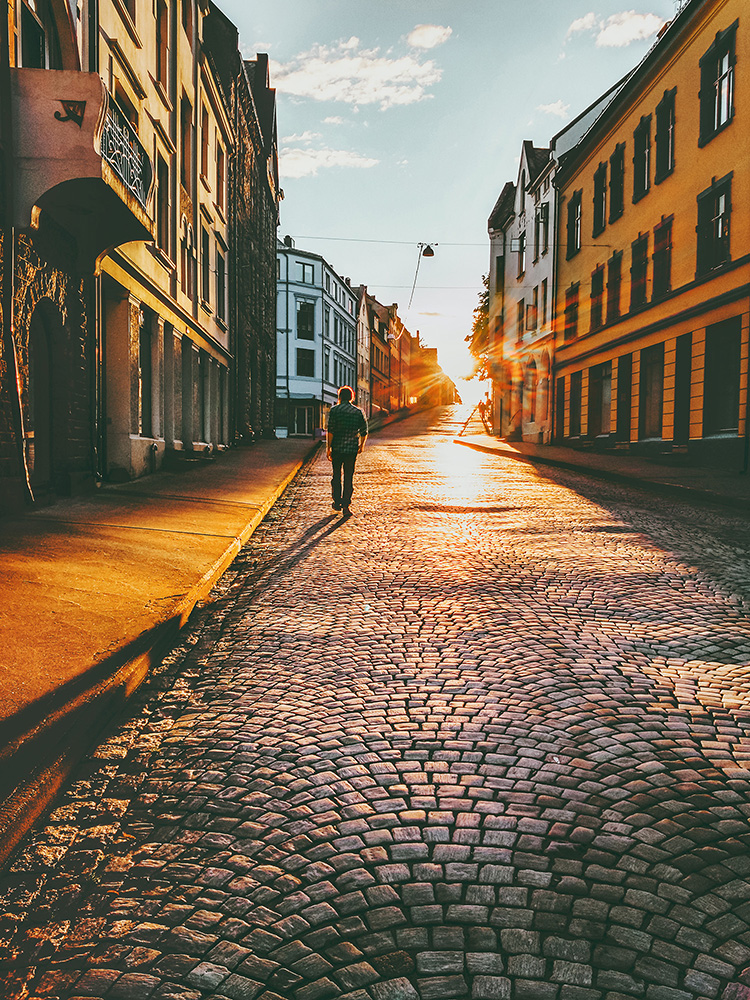 man male wandering town deserted evening sunset yellow orange shilouette photography cobbles vintage retro old long shadow travel photography